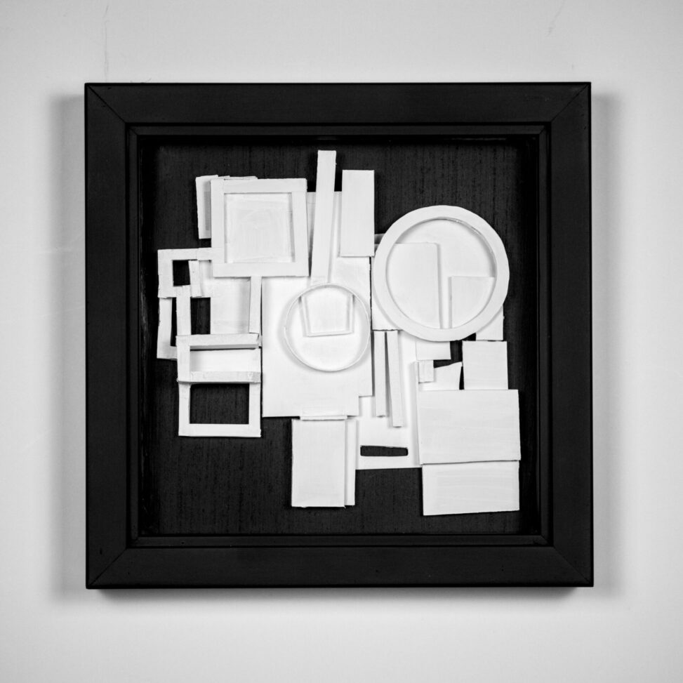 Interpreter, 3D assemblage by Laura Kinney with white foam core and mat board geometric forms on a black ground