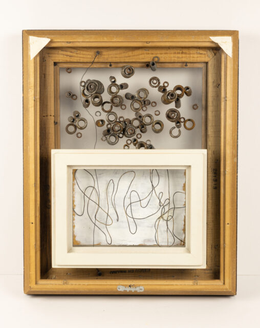 Clock in a Snowstorm, assemblage by Laura Kinney with found snow chain coils and wire on glass in a backwards thrifted frame